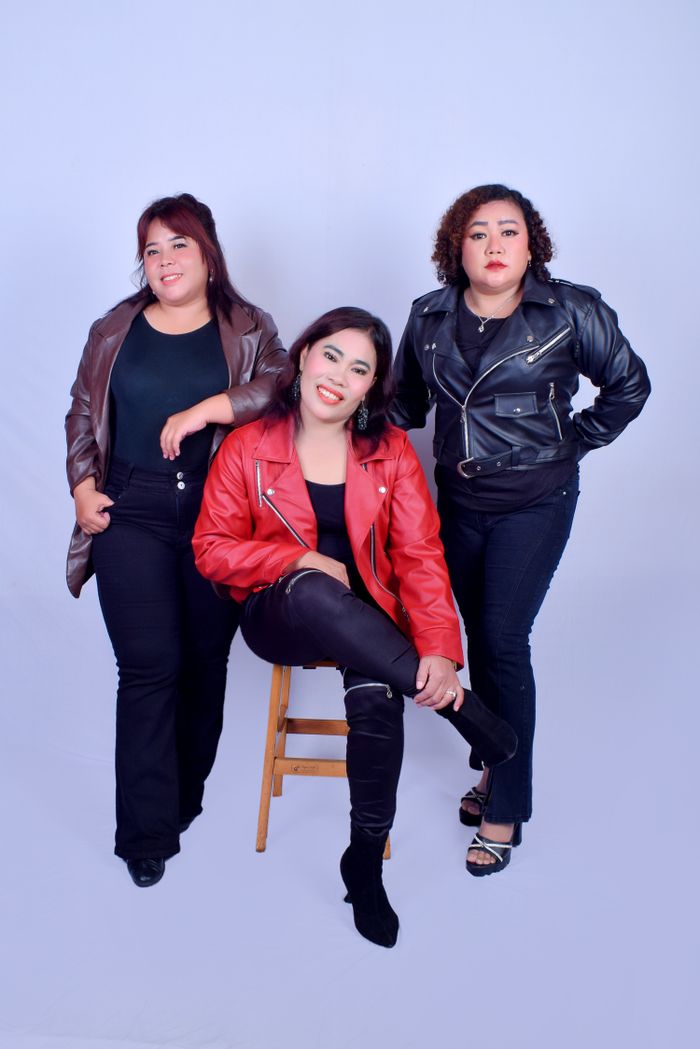 Mastering the First Impression: Your intriguing post title goes here Three confident women posing together in leather jackets against a studio backdrop.